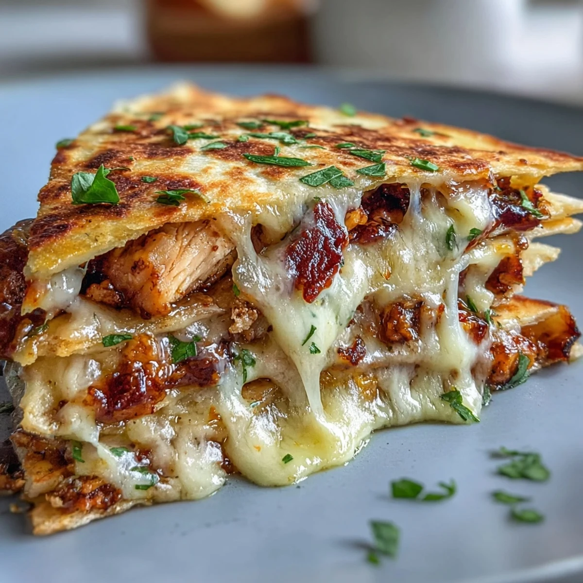 Cheesy Hot Honey Chicken Quesadillas garnished with fresh cilantro, resting on a rustic plate ready to be eaten.