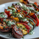Smoky, tender grilled veggie kabobs bursting with fresh flavors, drizzled with sauce.