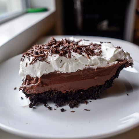 This delicious Mississippi Mud Pie is a rich, fudgy dessert with a topping of fluffy whipped cream.