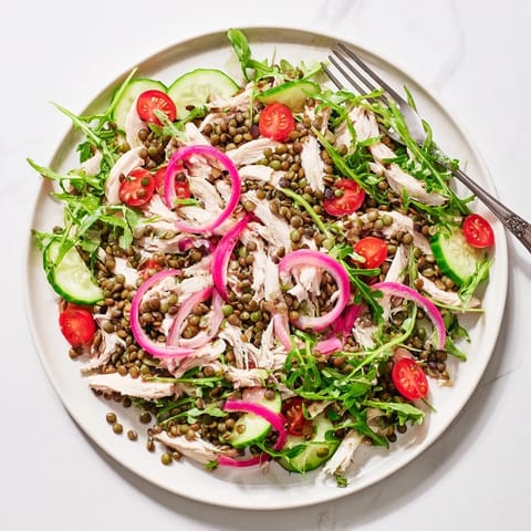 Close-up of Lentil & Chicken Spring Salad featuring juicy chicken, vibrant greens, and a zesty mustard dressing for a refreshing meal.