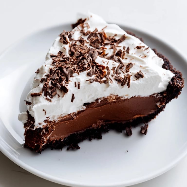 Image of a beautifully presented Mississippi Mud Pie, perfectly layered and garnished with chocolate shavings.