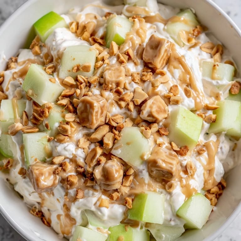 Creamy Snickers Salad, a quick dessert with chopped Snickers and fresh apple chunks.