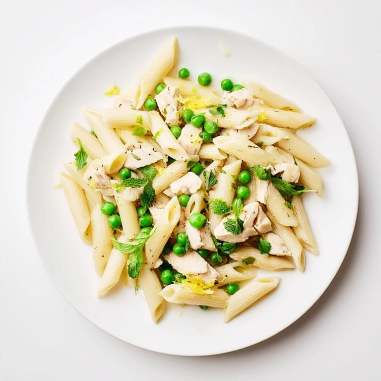 Plated Pea & Mint Chicken Pasta in a skillet, steam rising from the al dente noodles and vibrant spring vegetables.