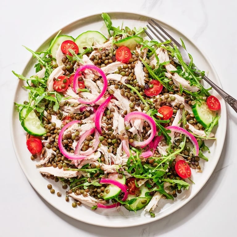 Close-up of Lentil & Chicken Spring Salad featuring juicy chicken, vibrant greens, and a zesty mustard dressing for a refreshing meal.