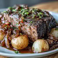 Savory onion soup mix slow cooker pot roast with tender beef and hearty vegetables in a rich, flavorful gravy.  